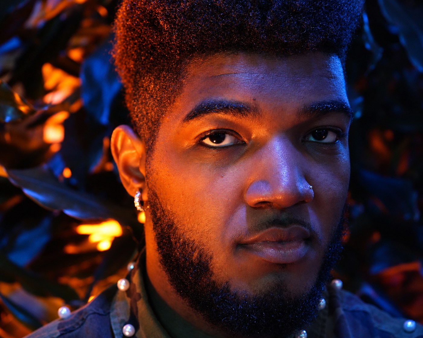 Close-up portrait with copper and blue light across the face