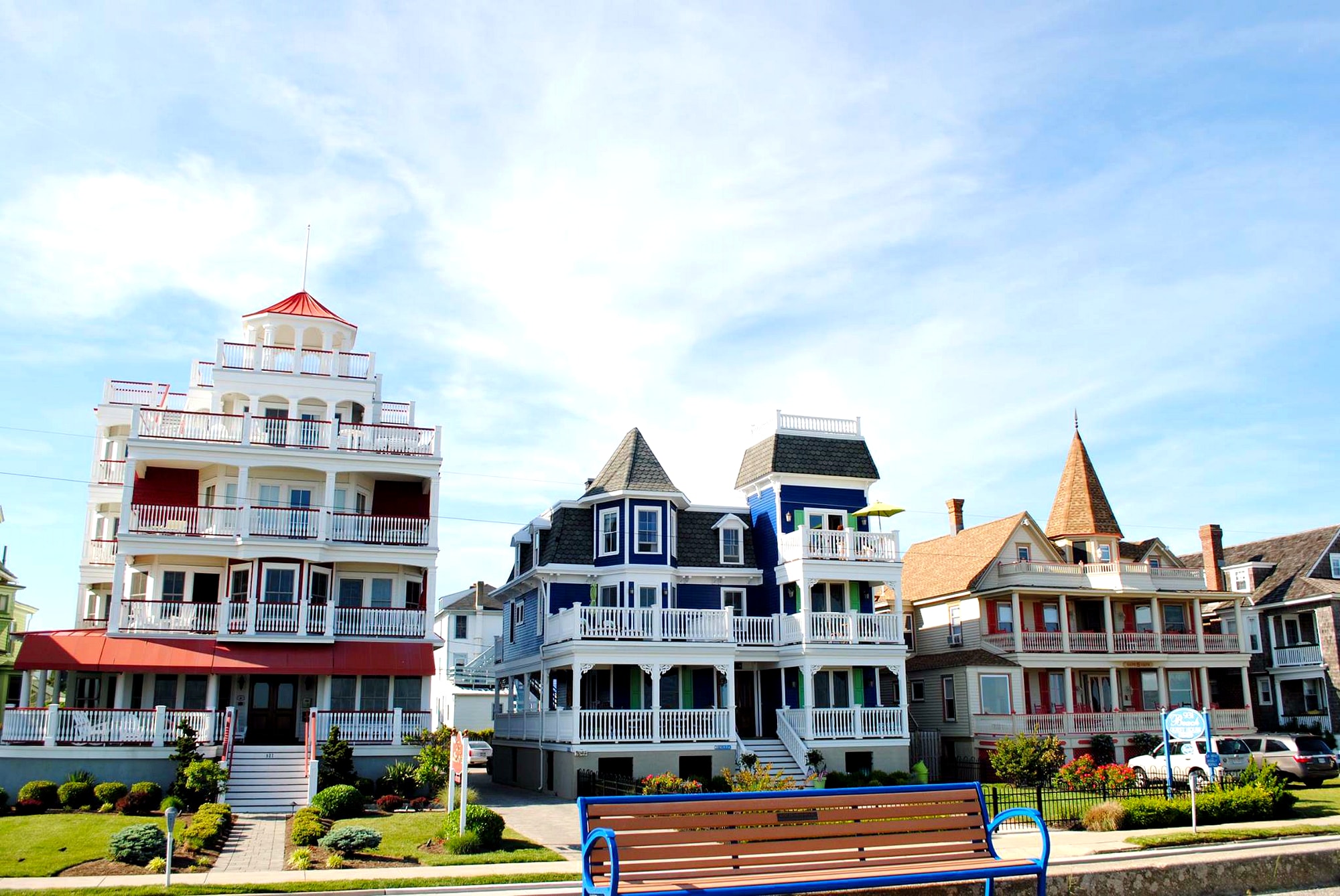 Colorful coastal houses beneath a softly clouded sky