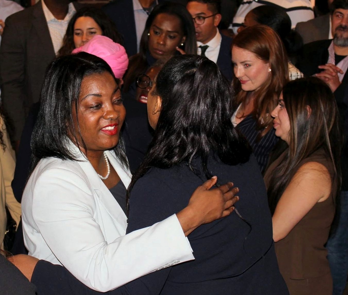 A candid moment among guests on a crowded dance floor