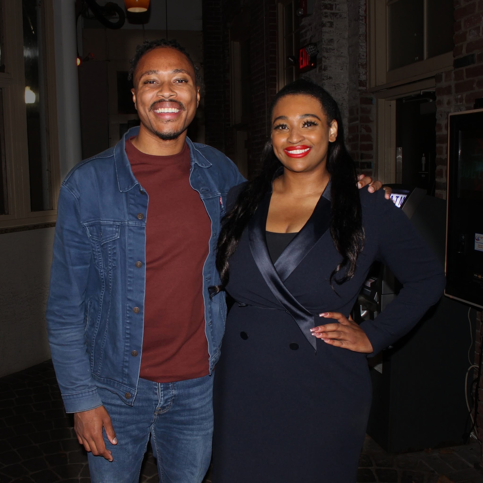 Two guests smiling together at an evening event