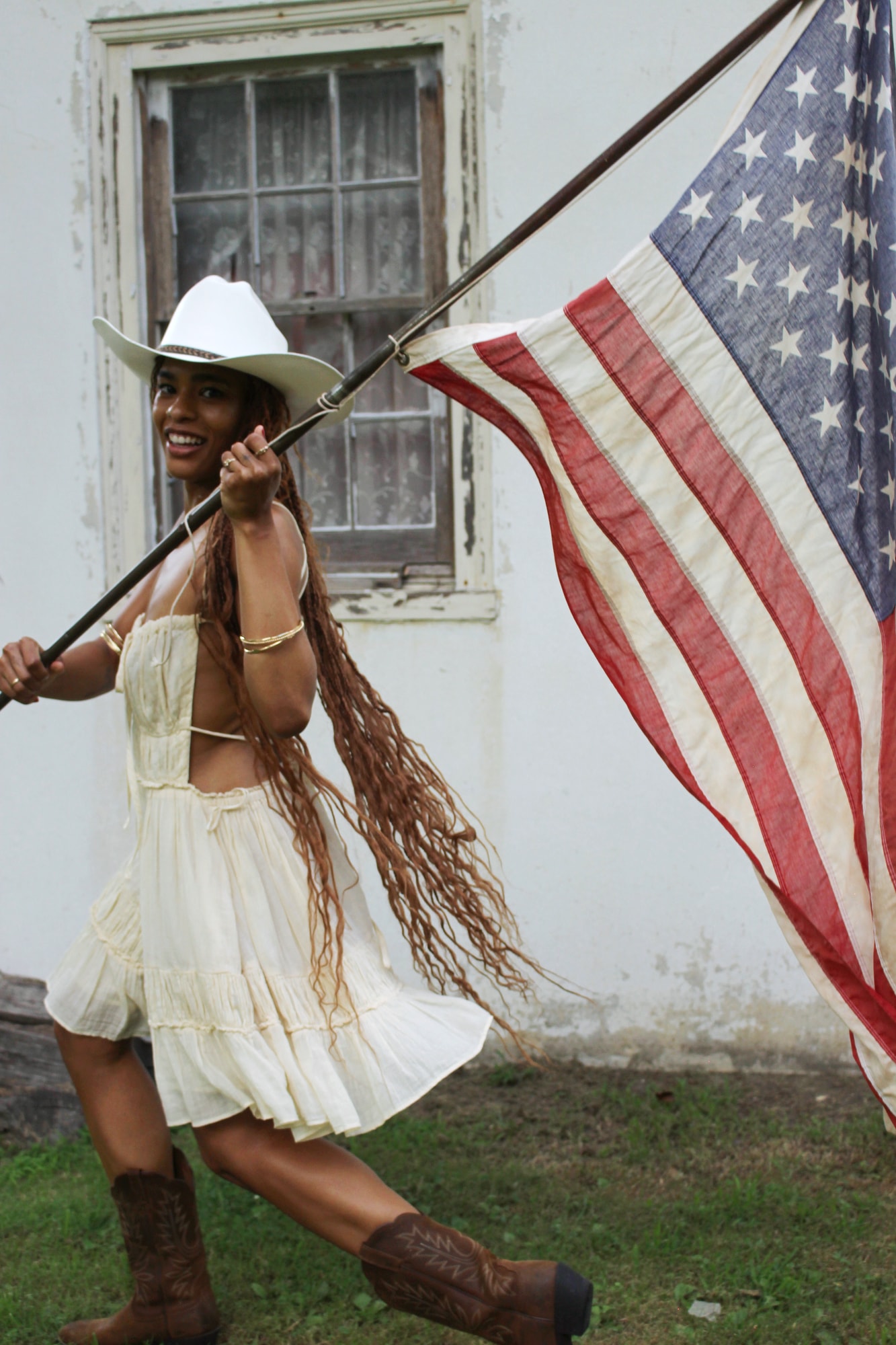 Portrait walking with an American flag outside a historic building